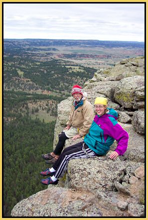 Kristen & Frank dangle feet over the West Face of Devils Tower